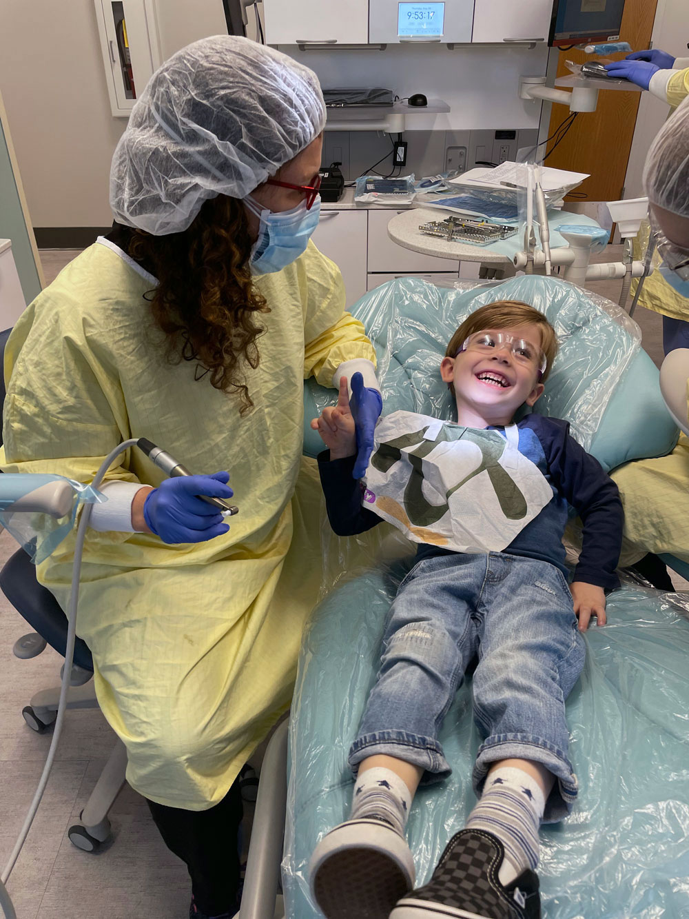 Child smiling while getting his teeth cleaned
