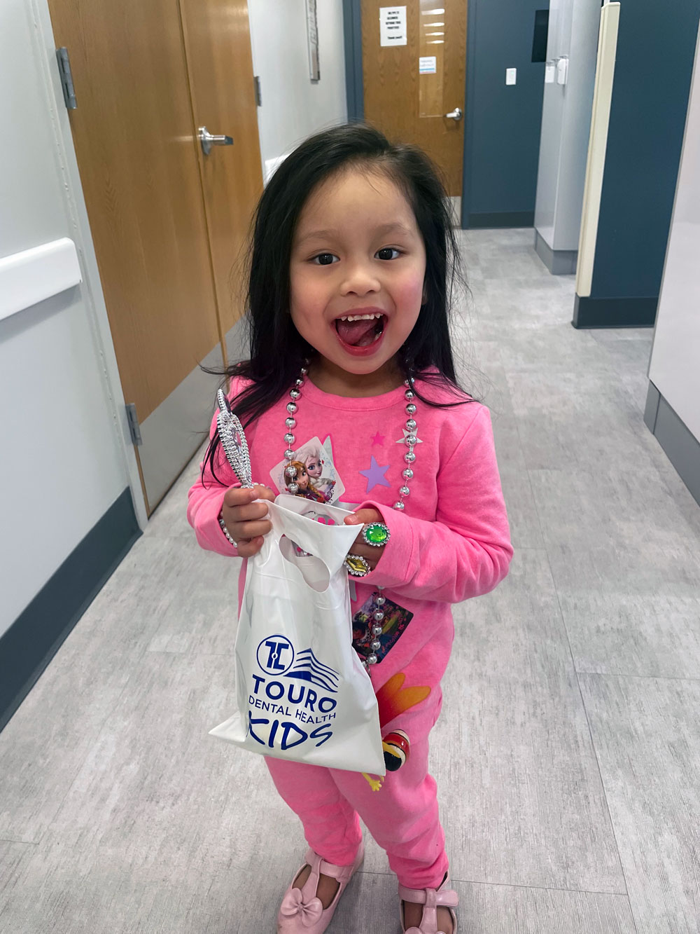 Female patient smiling with goody bag