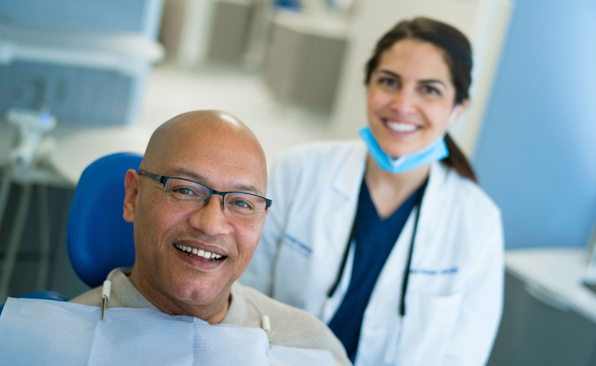 Dentist and patient smiling during appointment