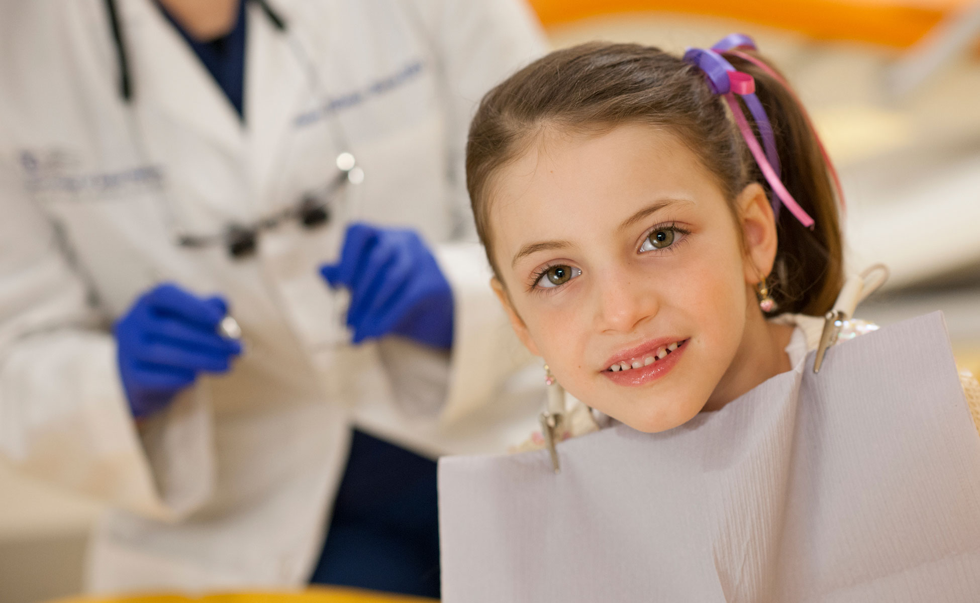 Female pediatric patient smiling while in chair at office
