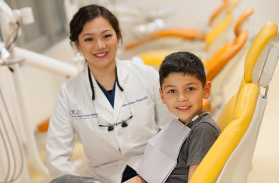 Touro dental student with young patient