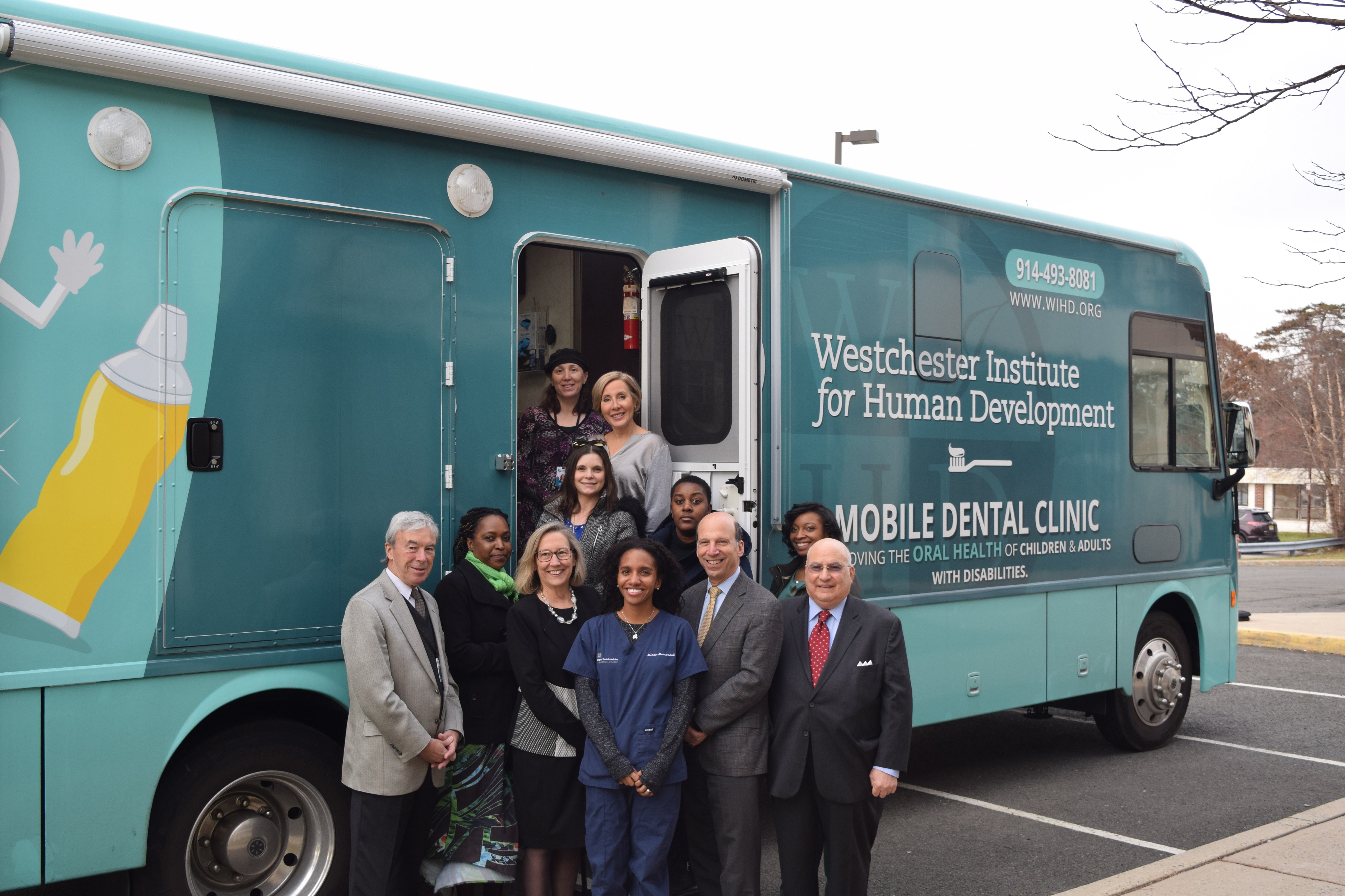 Group Photo in front of Bus labeled: Westchester Institute for Human Development Mobile Dental Clinic 
