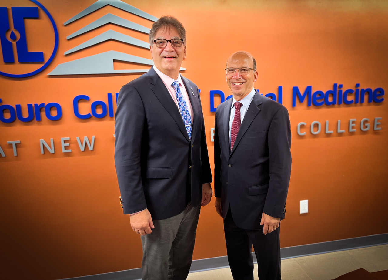 Dr. Ray Cohlmia Executive Director, ADA, left, and Touro College of Dental Medicine dean Dr. Ronnie Myers, right, in front of Touro College of Dental Medicine signage at the school during his touro of the school and clinic in Hawthorne, New York.