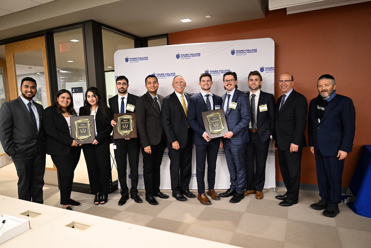 Faculty and students at Touro College of Dental Medicine hold the awards and commendations they received during the school\'s second annual Research Day. 