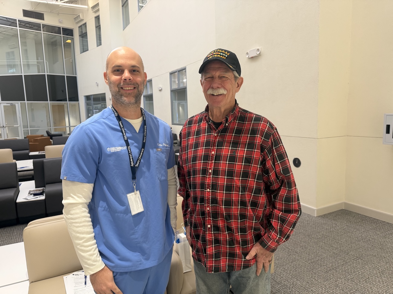 A touro dental student with a veteran. 