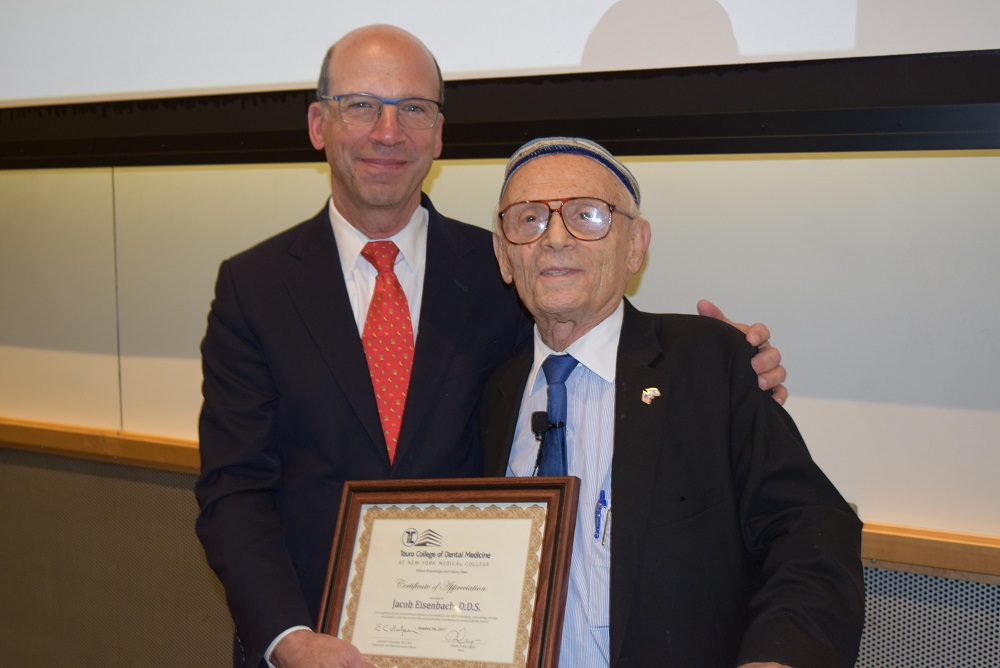Ronnie Meyers, D.D.S., dean of the Touro College of Dental Medicine, presented Dr. Eisenbach with a plaque in recognition of his “extraordinary lifetime achievement in the field of dentistry, astonishing courage and bravery in the face of adversity and invaluable contribution to causes of global justice.” 