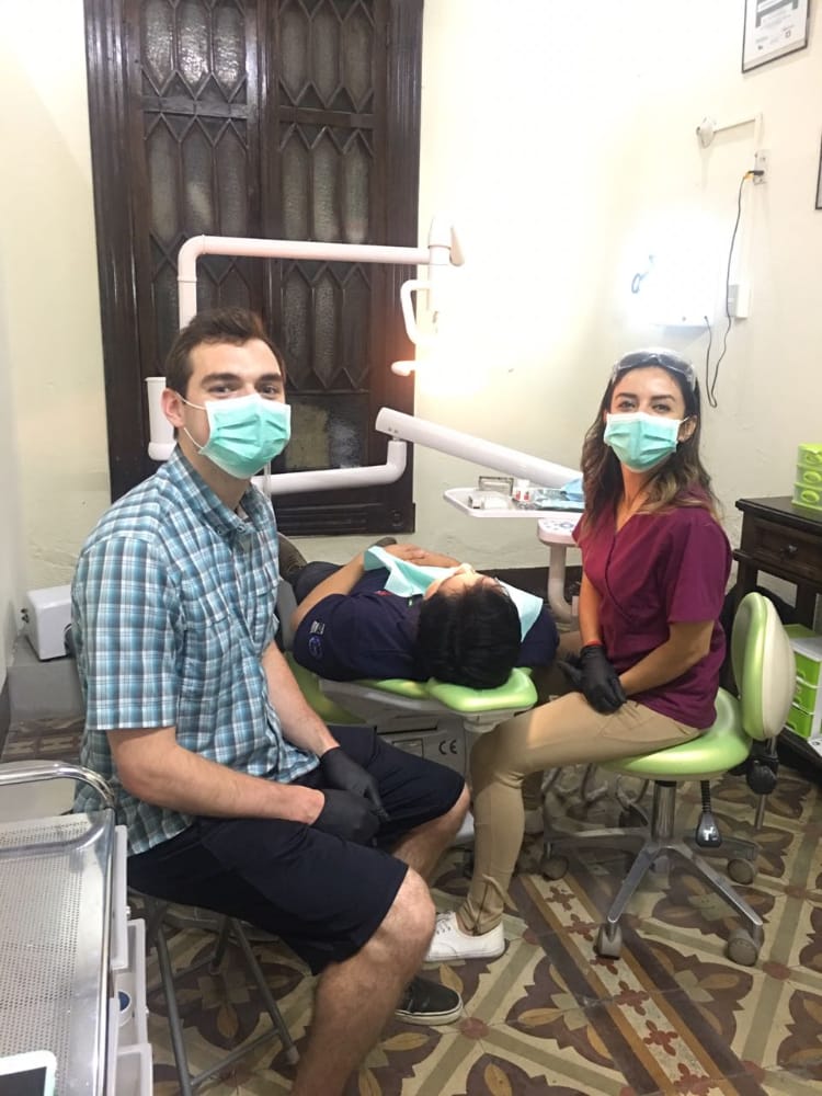 Andrew Gibbs with two other dental students in a clinical setting