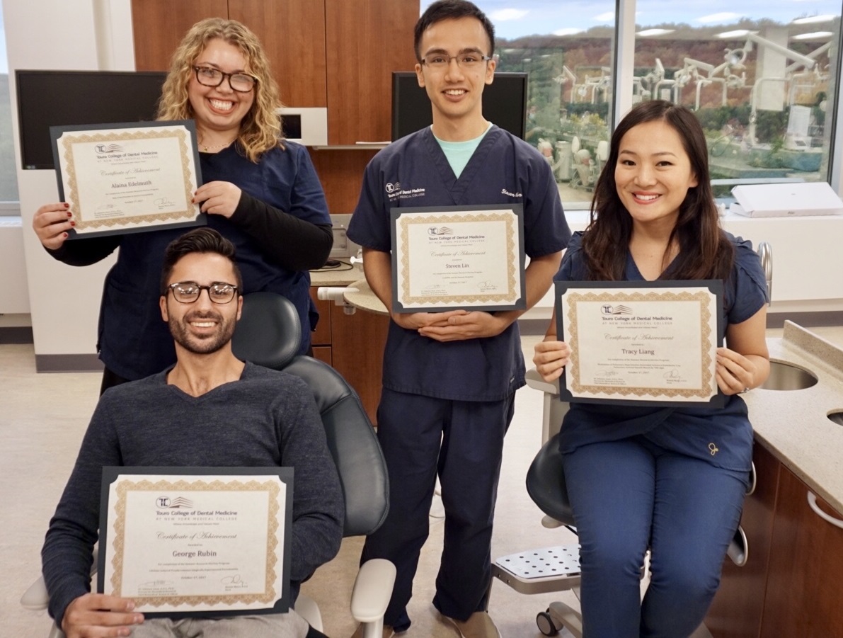 three students hold research awards