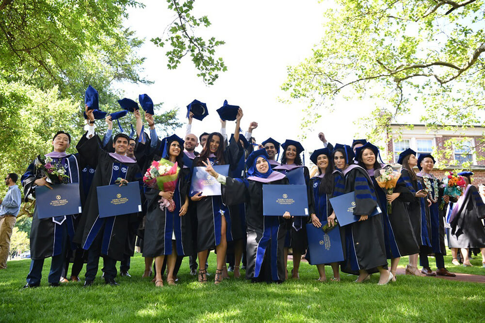 Group of Touro College of Dental Medicine graduates celebrate outside at commencement