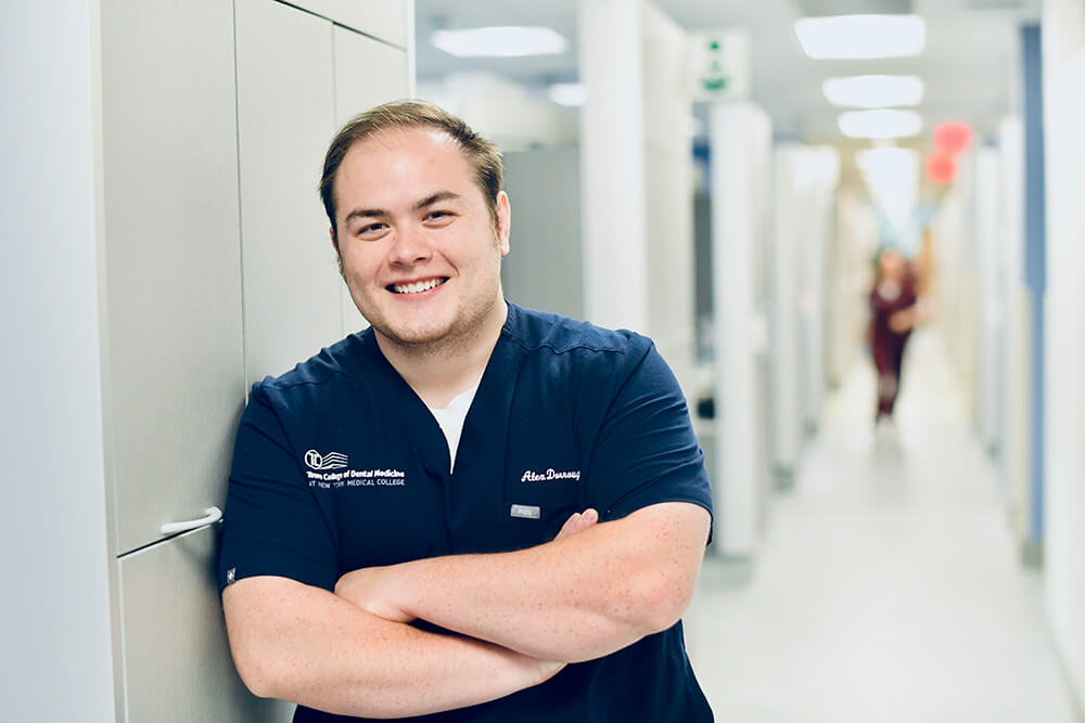 Alex Dorrough standing by hallway in Touro College of Dental Medicine